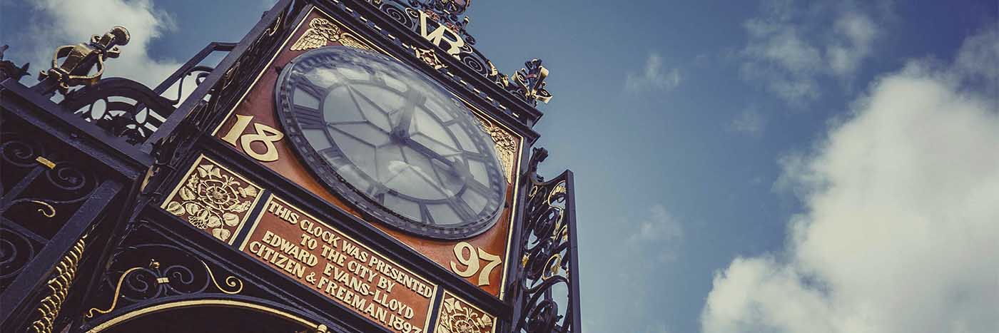 The Eastgate Clock in Chester, ornate ironwork against a blue sky
