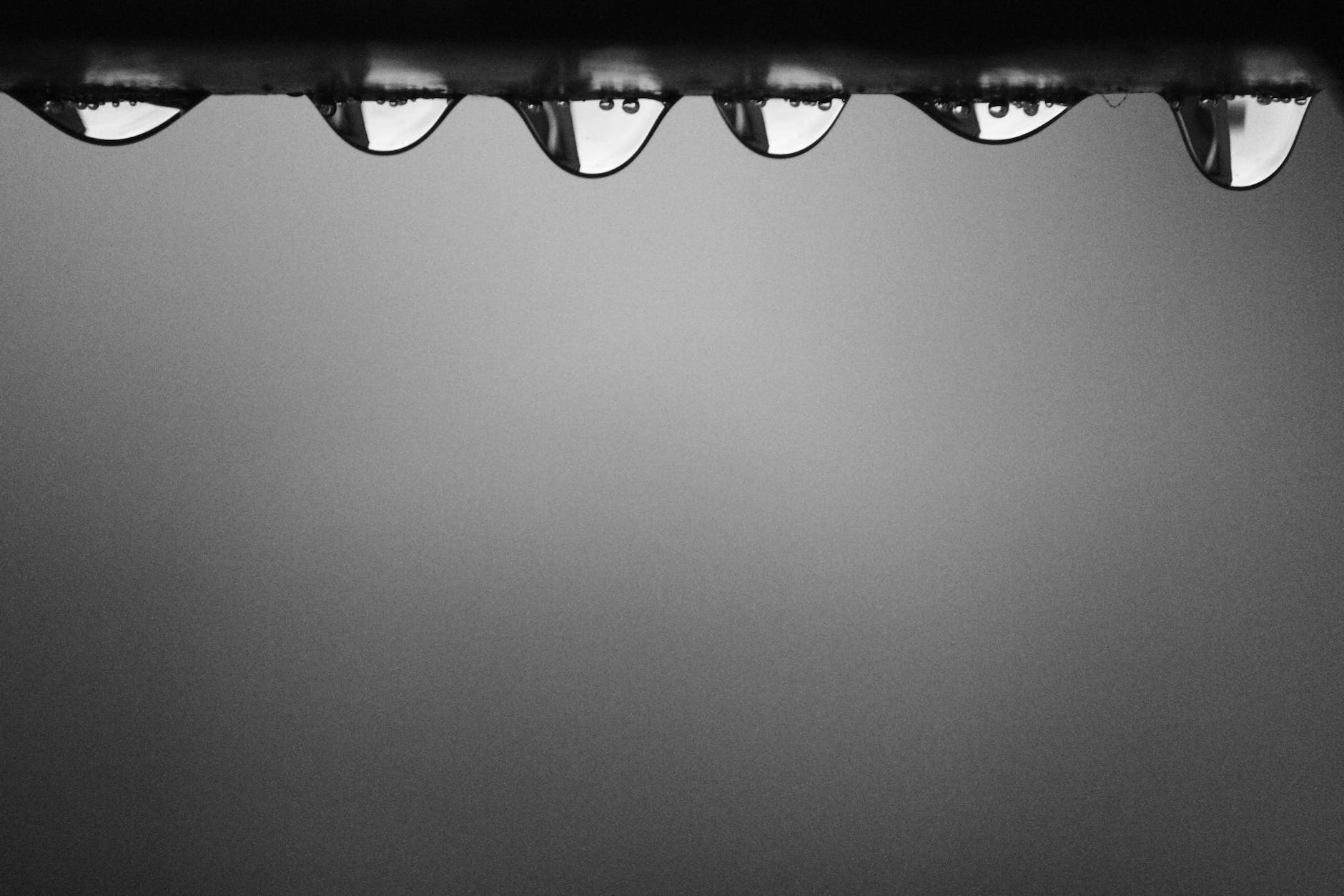 A row of studio lights across the top of a dark grey backdrop