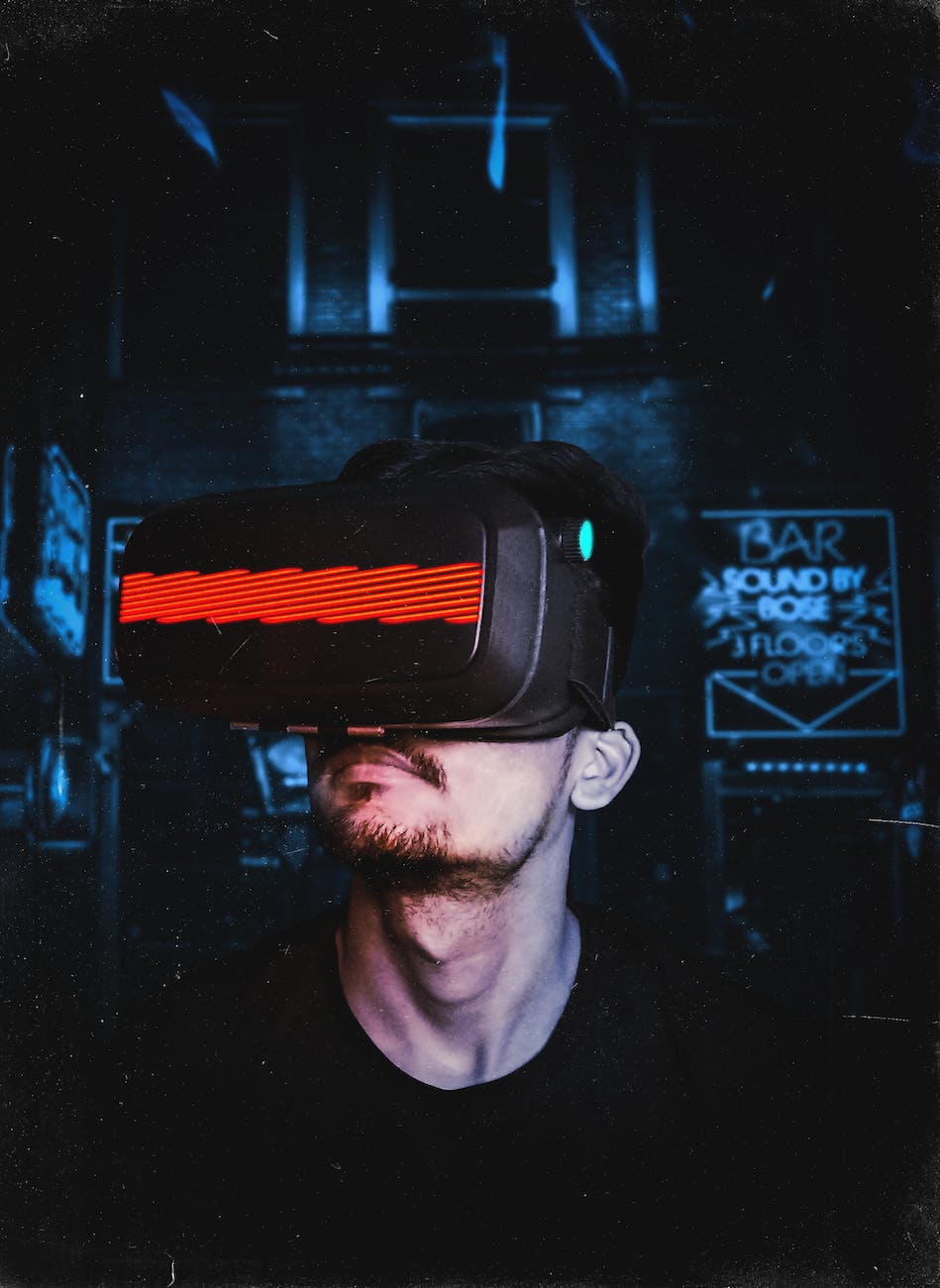 A person wearing a virtual reality headset lit by red and blue light