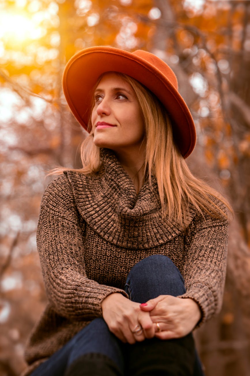 a blonde lady in an orange hat in the autumn sunshine