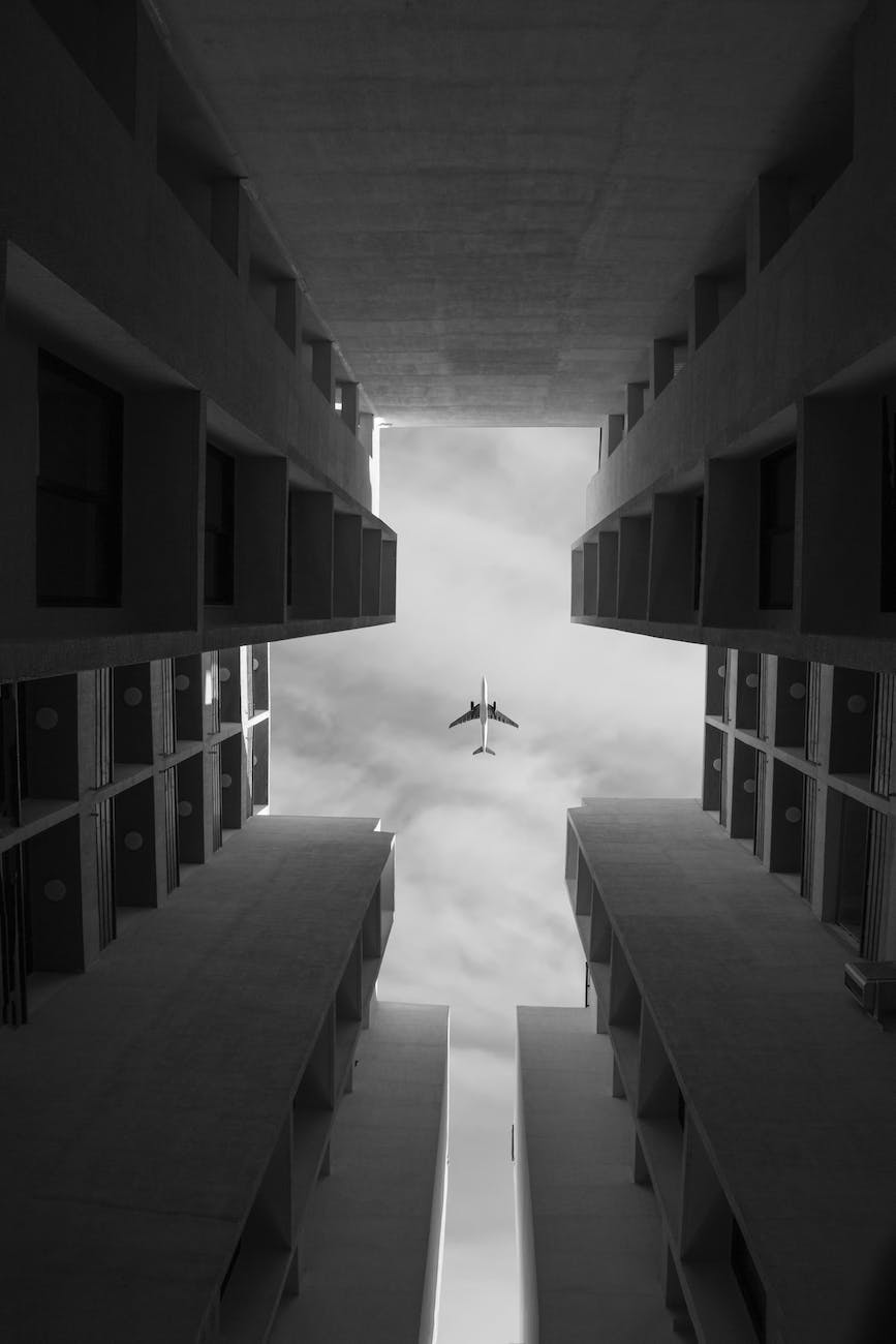 a plane flying over the top of buildings