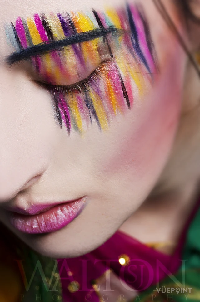 A close beauty portrait with brightly coloured make-up