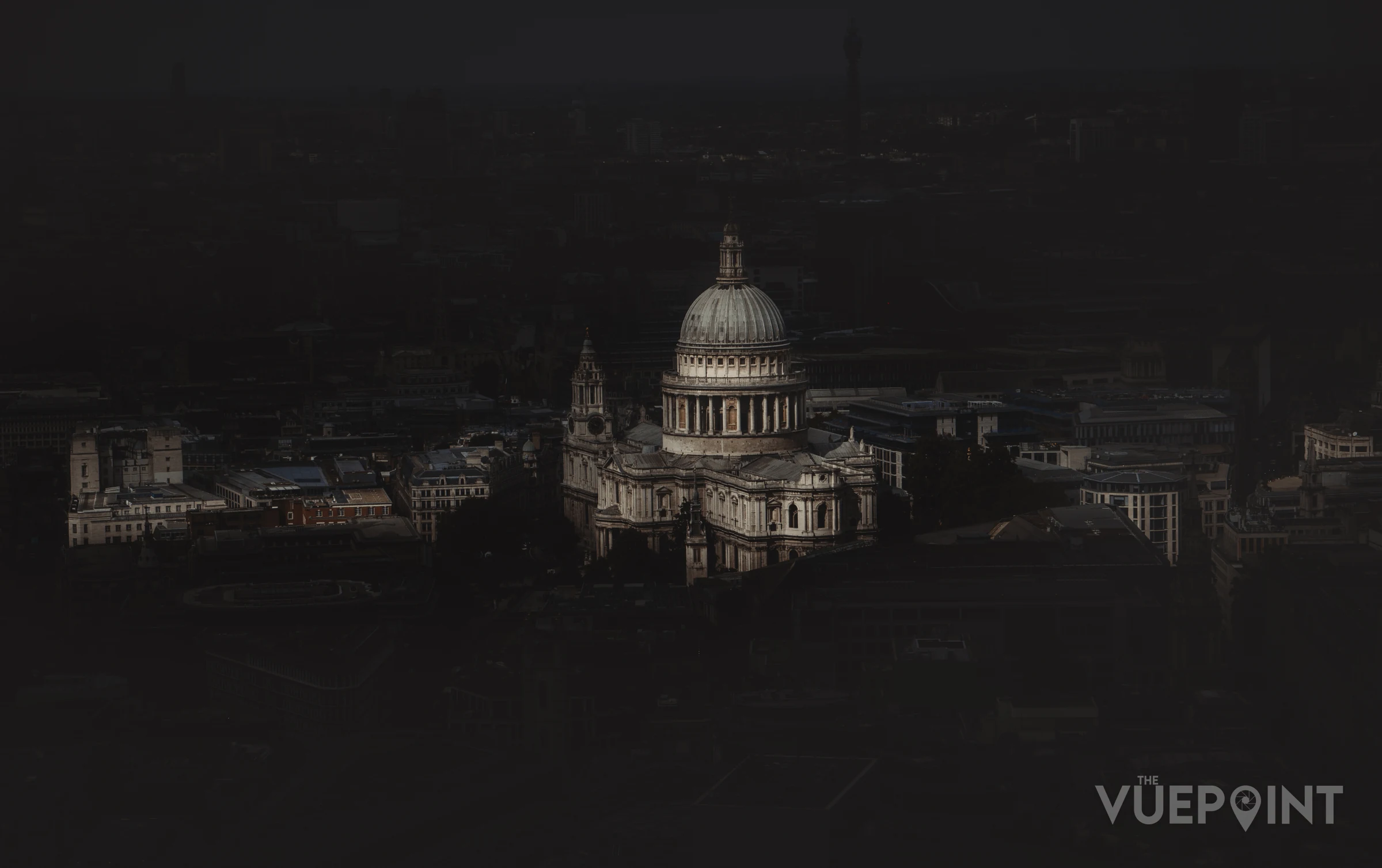 St Paul's Cathedral lit at night above a dark London skyline