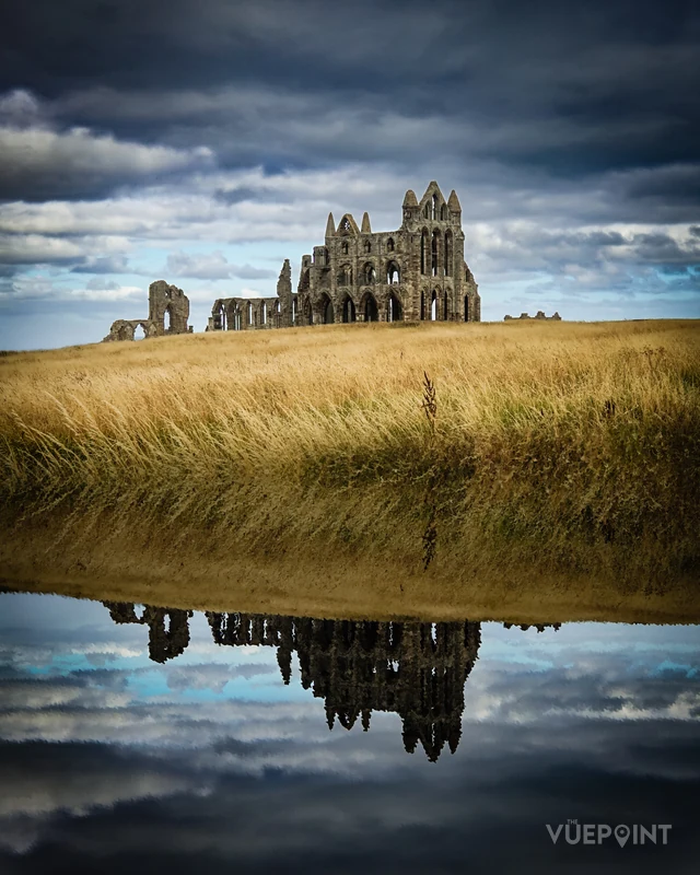 Whitby Abbey reflected in still water