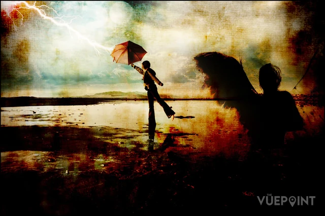 Two silhouetted figures with umbrellas on a washed-out shore