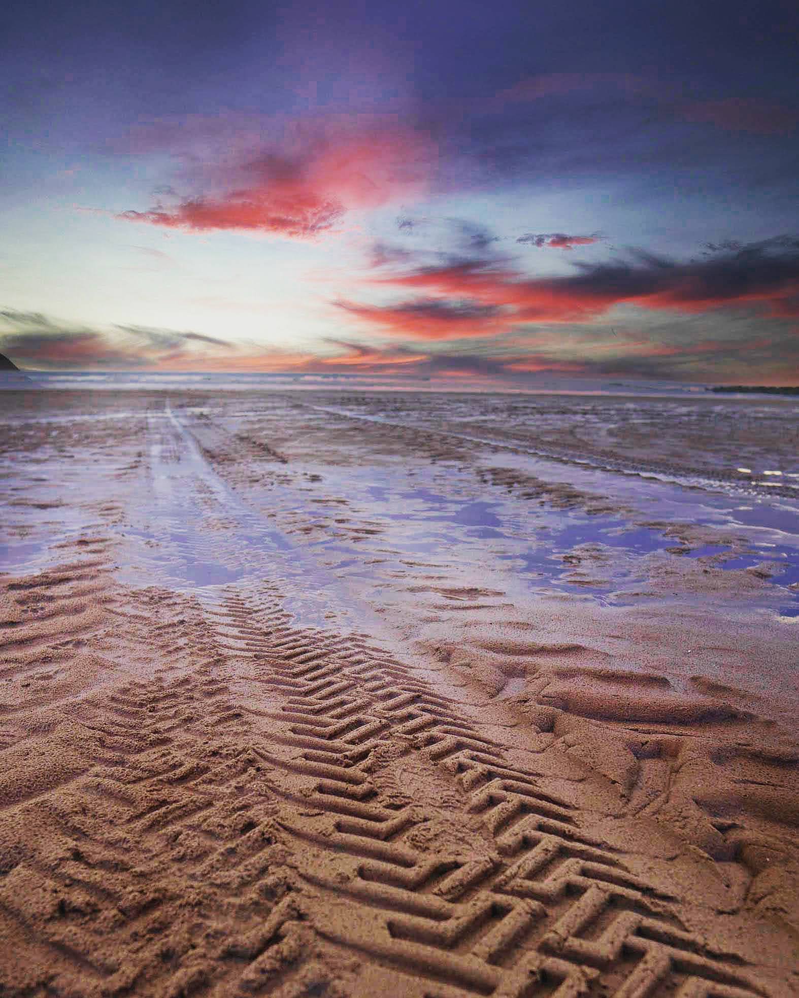 Tire tracks on the beach at Formby at sunset