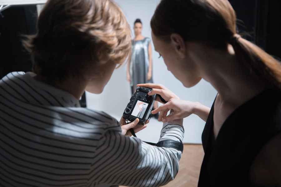 photographers looking at a camera