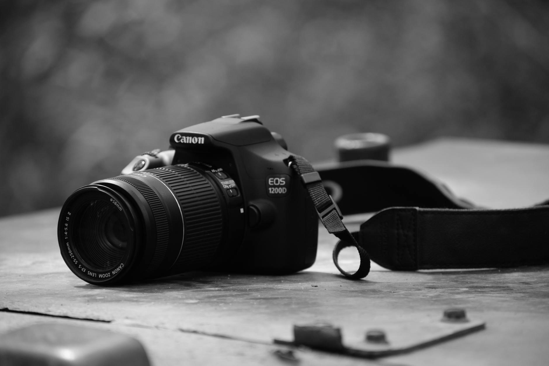 black and white photo of a Canon 1200D camera