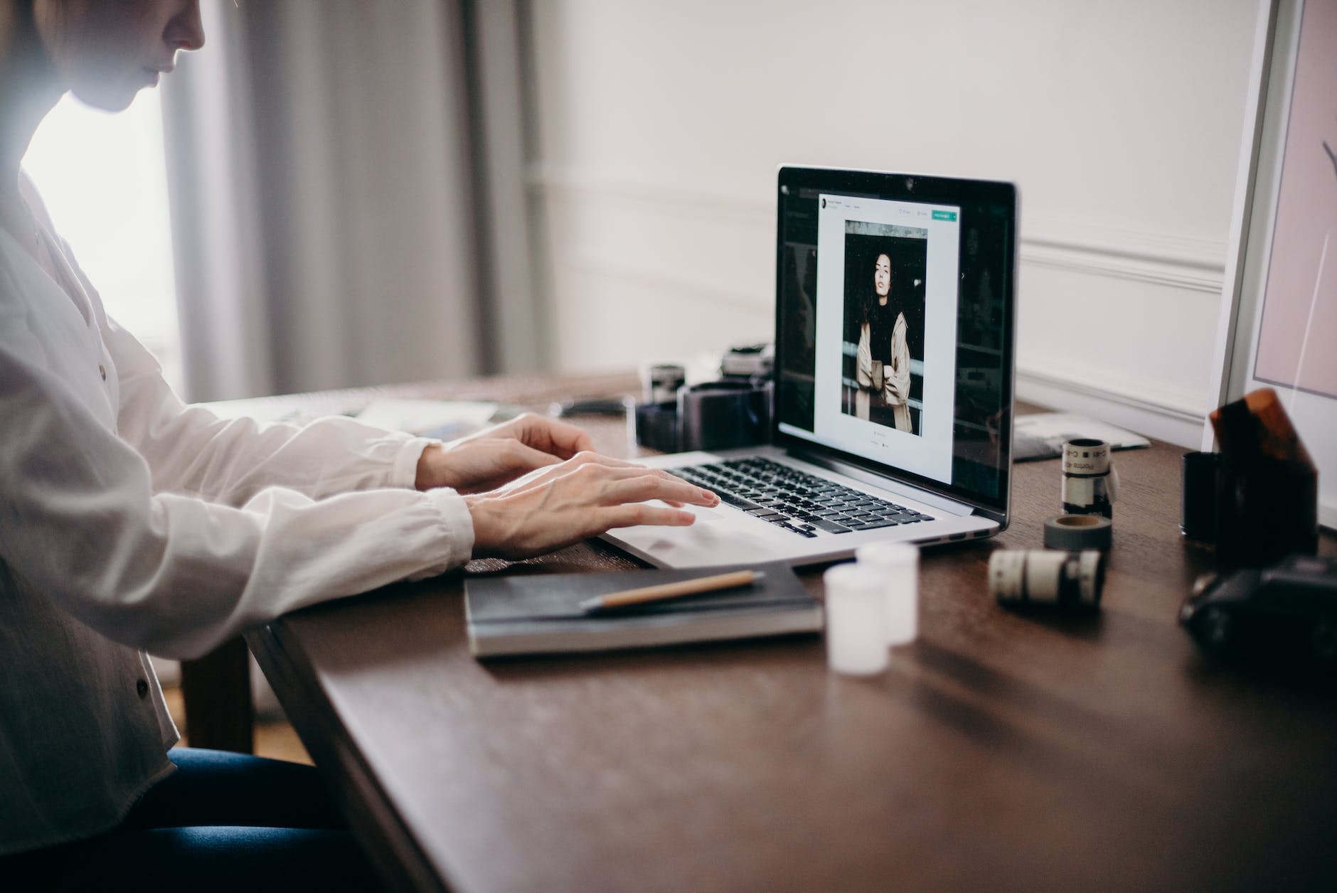 a woman editing photos on a laptop