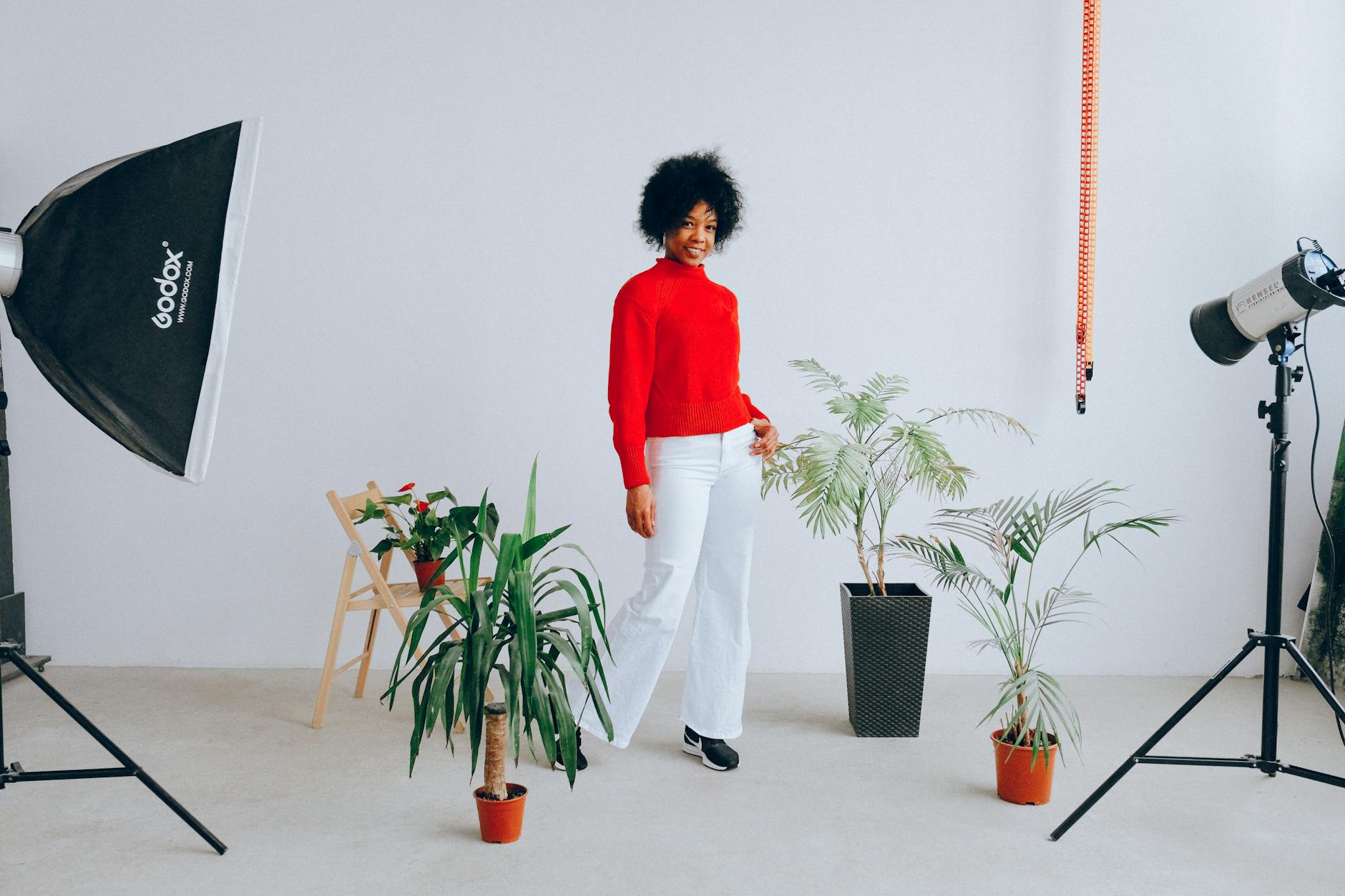 lady in a photo studio wearing a red jumper