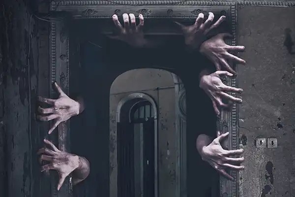 multiple hands grappling around the edge of a door frame like out of a nightmare